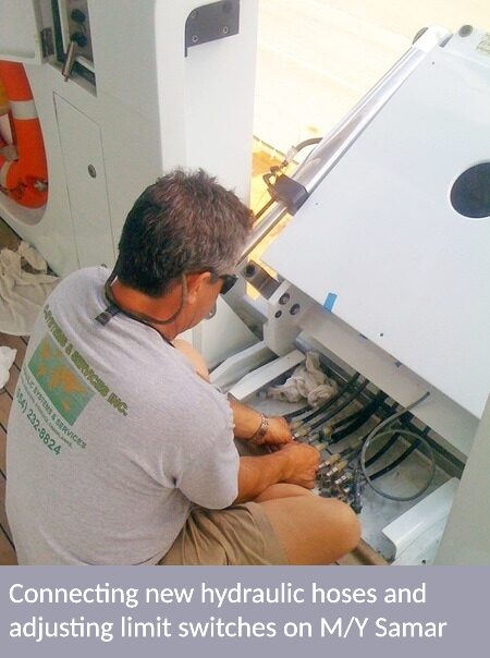 a man connecting new hydraulic hoses and adjusting limit switches on M/Y samar