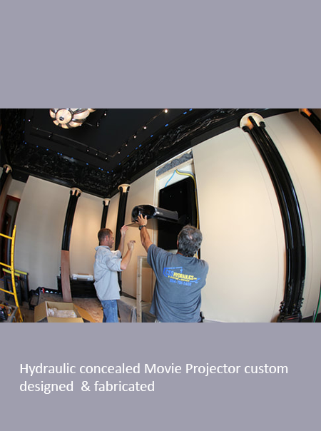 two people setting up a hydraulic concealed movie projector