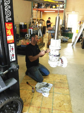 a person rebuilding a windlass at a workshop