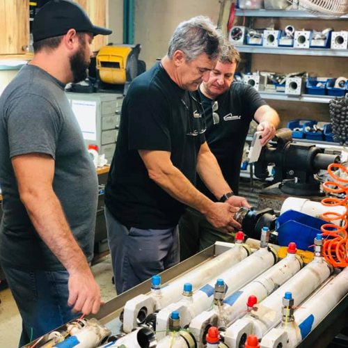 a group of people modifying steering systems